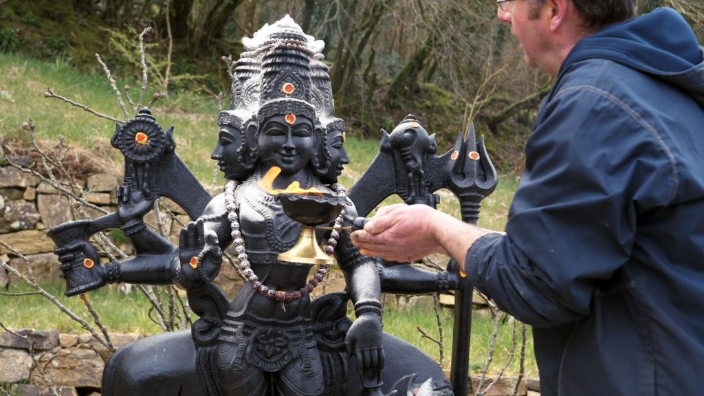 Swami Govinda offers aarthi to Lord Dattatreya at Skanda Vale