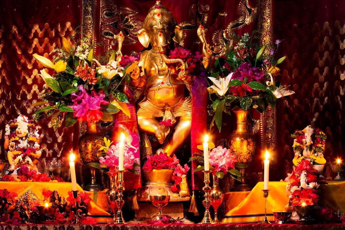Lord Ganesha A beautiful shrine to Lord Ganesh with flowers and lamps