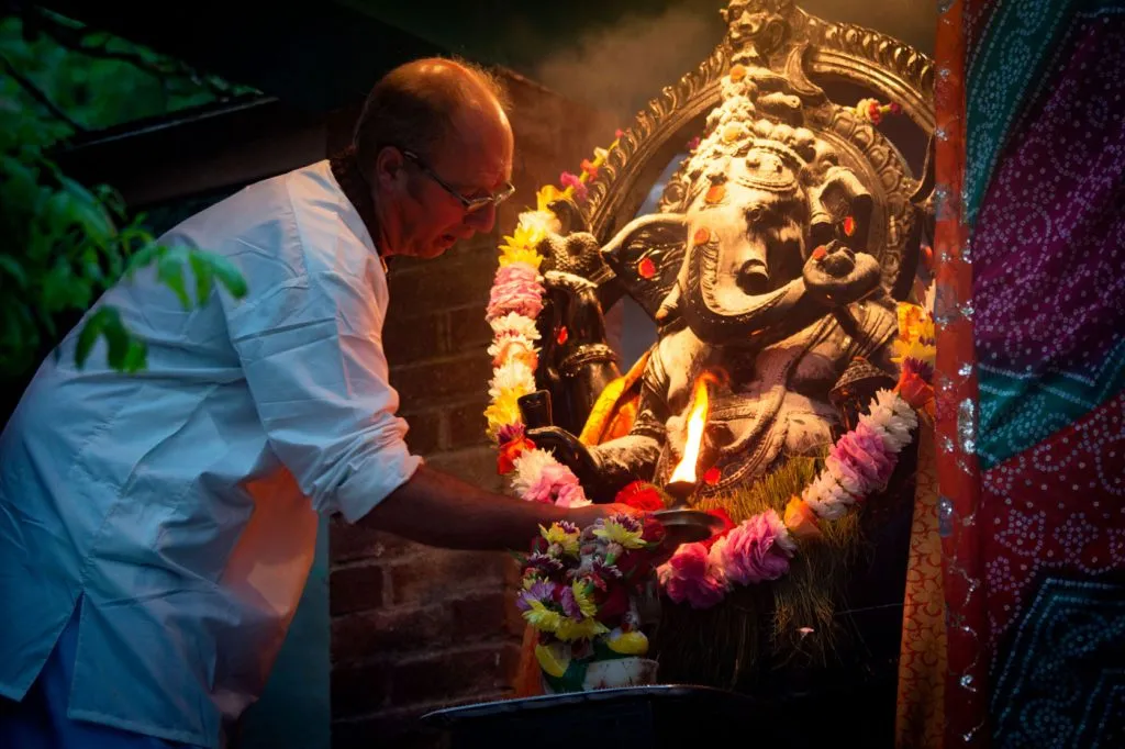 Swami Govinda offers aarthi to a murthi of Lord Ganesh