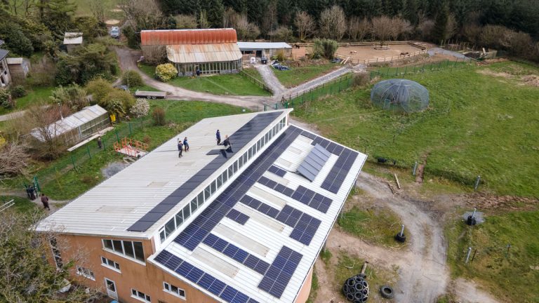 Solar panels for hot water and electricity on the roof of a barn